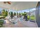 Relax on this screened porch with wicker furniture and enjoy views of the landscaped backyard at 932 Abernathy Place, Surfside Beach, SC 29575