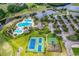 Aerial view of community pool, tennis courts, playground, and parking area with lush landscaping at 1009 Maccoa Dr., Conway, SC 29526