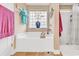 Bright bathroom featuring a tub, shower, and decorated with plants and artistic decor at 1009 Maccoa Dr., Conway, SC 29526