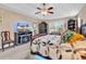 Comfortable main bedroom featuring a fireplace, ceiling fan, and bright, airy natural light at 1009 Maccoa Dr., Conway, SC 29526