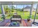 Relaxing screened porch offering outdoor living space with views of the lush backyard and pond at 1009 Maccoa Dr., Conway, SC 29526