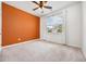 Bedroom with orange accent wall, ceiling fan, and window with blinds at 1016 Laurens Mill Dr., Myrtle Beach, SC 29579