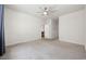 Carpeted bedroom with ceiling fan, white walls, and doorway to a kitchen area at 1016 Laurens Mill Dr., Myrtle Beach, SC 29579
