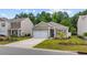 Single-story home with a well-maintained lawn, driveway, and a two-car garage nestled in a quiet neighborhood at 1016 Laurens Mill Dr., Myrtle Beach, SC 29579