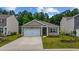 Charming single-story home featuring a well-manicured lawn, a driveway, and a two-car garage at 1016 Laurens Mill Dr., Myrtle Beach, SC 29579
