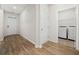 Hallway with wood floors leading to the laundry room and the front door at 1016 Laurens Mill Dr., Myrtle Beach, SC 29579