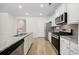Well-equipped kitchen featuring a center island, stainless steel appliances, and bright white cabinetry at 1016 Laurens Mill Dr., Myrtle Beach, SC 29579