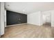 Spacious living room with a dark accent wall, wood-look flooring and a neutral palette at 1016 Laurens Mill Dr., Myrtle Beach, SC 29579