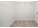 Walk-in closet with wire shelving and neutral carpet perfect for closet organization at 1016 Laurens Mill Dr., Myrtle Beach, SC 29579