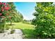 Beautiful backyard with lush green lawn, mature trees, and white rock border at 1025 Plantation Dr. # 2413/2414, Little River, SC 29566
