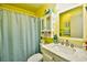 Bathroom with updated vanity, sink, mirror and tub/shower combination with light blue curtain at 1025 Plantation Dr. # 2413/2414, Little River, SC 29566
