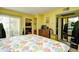 Bright bedroom features a seashell-patterned comforter, dresser, closet, and sliding glass door at 1025 Plantation Dr. # 2413/2414, Little River, SC 29566