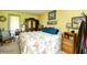Bright bedroom features a seashell-patterned comforter, wooden furniture, and beach-themed decor at 1025 Plantation Dr. # 2413/2414, Little River, SC 29566