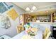 A brightly decorated dining area with colorful accents and an open view to the kitchen at 1025 Plantation Dr. # 2413/2414, Little River, SC 29566