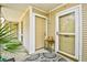 Inviting entrance featuring a screen door, neutral siding, and a cozy outdoor seating area with lush greenery at 1025 Plantation Dr. # 2413/2414, Little River, SC 29566