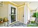 Welcoming front porch area with a patterned rug, charming decor, a screen door, and a neutral-colored front door at 1025 Plantation Dr. # 2413/2414, Little River, SC 29566