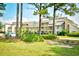 Well-maintained condo building with multi-level balconies and mature landscaping creating a tranquil, inviting atmosphere at 1025 Plantation Dr. # 2413/2414, Little River, SC 29566