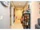 Well-lit hallway with decor, neutral walls, tile floors, and access to laundry area and other rooms at 1025 Plantation Dr. # 2413/2414, Little River, SC 29566