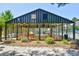 Enclosed community pool with glass walls, lounge chairs, and tropical landscaping at 1025 Plantation Dr. # 2413/2414, Little River, SC 29566