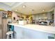 Kitchen featuring a long bar with counter seating, bright lighting, and ample cabinet space at 1025 Plantation Dr. # 2413/2414, Little River, SC 29566