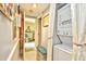 Bright hallway laundry area with stacked washer and dryer, and doorway to bedroom at 1025 Plantation Dr. # 2413/2414, Little River, SC 29566