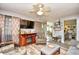 Bright living room with stylish furnishings, a ceiling fan, a TV, and an open layout flowing into the kitchen at 1025 Plantation Dr. # 2413/2414, Little River, SC 29566