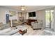 Inviting living room with a ceiling fan, comfortable seating, a large TV, and sliding glass doors to a balcony at 1025 Plantation Dr. # 2413/2414, Little River, SC 29566