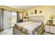 The main bedroom featuring sliding glass door with patio access and decorative furnishings at 1025 Plantation Dr. # 2413/2414, Little River, SC 29566