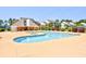 Community pool with lounge chairs, surrounding buildings, and lush landscaping at 1025 Plantation Dr. # 2413/2414, Little River, SC 29566