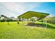 Open-air community picnic area featuring tables, a grill, and a large grassy area at 1025 Plantation Dr. # 2413/2414, Little River, SC 29566