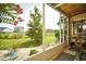 Relaxing screened porch features green plants, a ceiling, and a view of backyard at 1025 Plantation Dr. # 2413/2414, Little River, SC 29566