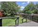 Backyard features a deck with metal railing overlooking a grassy yard with a wood fence at 1028 Duke St., Georgetown, SC 29440