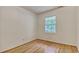 Simple bedroom with a window overlooking greenery and neutral walls and hardwood floors at 1028 Duke St., Georgetown, SC 29440