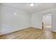 Minimalist bedroom with light wood floors, neutral walls, and doorway to other rooms at 1028 Duke St., Georgetown, SC 29440