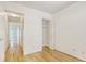 Bright bedroom with hardwood floors, showcasing closet space and hallway access at 1028 Duke St., Georgetown, SC 29440