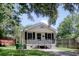 Charming home with neutral paint and dark shutters, landscaping and covered front porch at 1028 Duke St., Georgetown, SC 29440