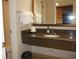 The bathroom features a granite vanity, decorative mirror, and fresh white towels for a comfortable experience at 1105 S Ocean Blvd. # 218, Myrtle Beach, SC 29577