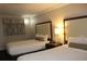 Cozy room featuring two inviting beds with decorative pillows and a simple, stylish bedside table at 1105 S Ocean Blvd. # 218, Myrtle Beach, SC 29577