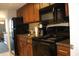 The kitchen is equipped with stainless steel appliances, granite countertops, and warm wooden cabinetry at 1105 S Ocean Blvd. # 218, Myrtle Beach, SC 29577