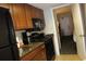 A fully-equipped kitchen with wood cabinets, black appliances, and granite countertops provides modern convenience at 1105 S Ocean Blvd. # 218, Myrtle Beach, SC 29577
