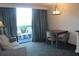 Living space includes seating and small dining table, plus a balcony with views at 1105 S Ocean Blvd. # 218, Myrtle Beach, SC 29577