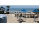 View of pool deck with lounge chairs and dining tables overlooking beach at 1105 S Ocean Blvd. # 218, Myrtle Beach, SC 29577