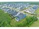 Extensive aerial view showcasing a community of houses with manicured lawns and tree-lined streets, promoting a serene atmosphere at 117 Black Water Dr., Murrells Inlet, SC 29576