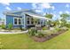 Beautiful backyard with a well-manicured lawn, patio, garden, and an outdoor kitchen area at 117 Black Water Dr., Murrells Inlet, SC 29576