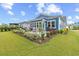 Landscaped backyard features an outdoor stone patio with seating and grilling area, perfect for enjoying the outdoors at 117 Black Water Dr., Murrells Inlet, SC 29576