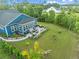 Aerial shot of a backyard featuring a patio, outdoor seating, a grill, and lush landscaping, ideal for relaxation at 117 Black Water Dr., Murrells Inlet, SC 29576