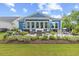 Serene backyard featuring a stone patio, outdoor seating, a grill, and beautiful landscaping, perfect for entertaining at 117 Black Water Dr., Murrells Inlet, SC 29576