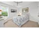 Comfortable bedroom with a ceiling fan and lots of natural light from the large window, creating a relaxing atmosphere at 117 Black Water Dr., Murrells Inlet, SC 29576