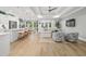 Open concept living space featuring hardwood floors, white sofas, and natural lighting at 117 Black Water Dr., Murrells Inlet, SC 29576