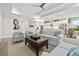 Open-concept living area with a modern ceiling fan, plush sofas, and a view into the kitchen at 117 Black Water Dr., Murrells Inlet, SC 29576